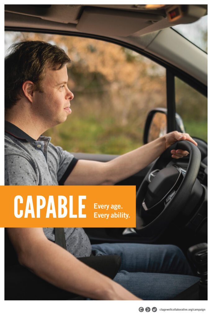 A young man with Down Syndrome sits at the wheel of a car. The headline says, "Capable. Every age. Every ability."