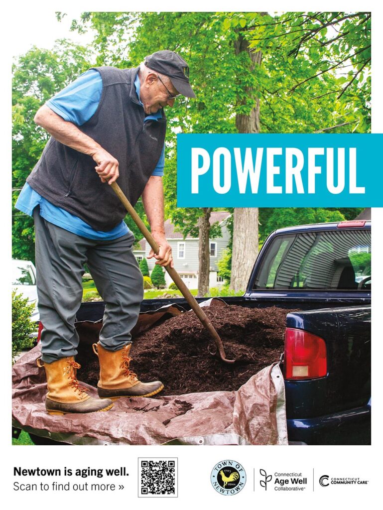 John standing in the bed of his pickup, shoveling mulch